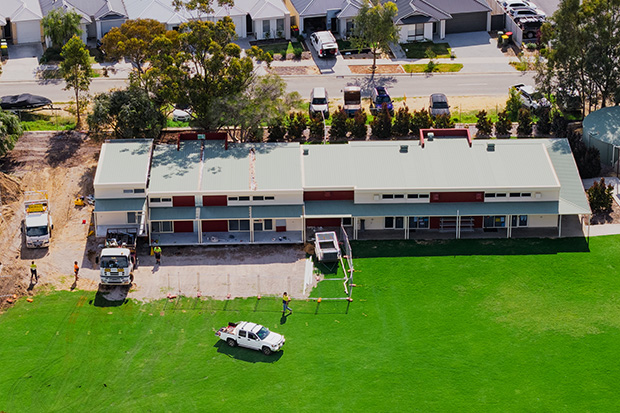 Demountable classroom with accessible ramps and covered walkways on a school campus