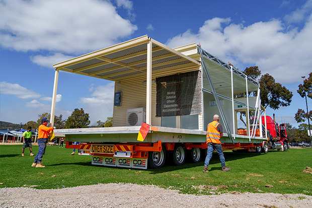 Rapid Modular WA demountable building securely loaded on a truck for delivery to a school site